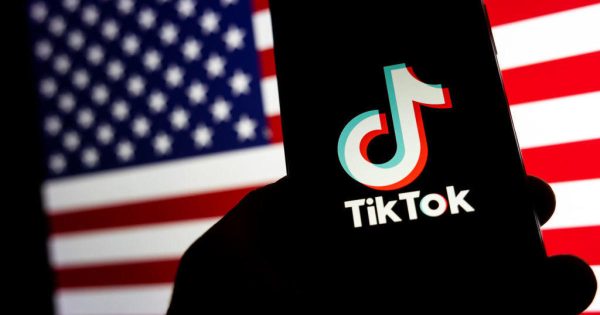 TikTok logo displayed on a mobile phone screen in front of the United States of America - USA -  flag is seen in this illustration photo taken in Milano, Italy, on March 03 2023  (Photo Illustration by Mairo Cinquetti/NurPhoto via Getty Images)